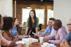 42307770 - female boss addressing office workers at meeting