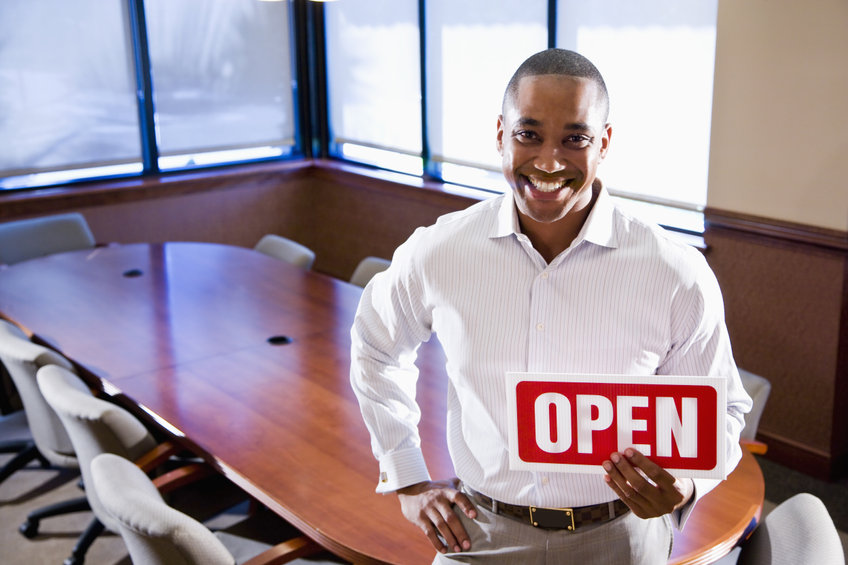 New entrepreneur holding open sign. He has just opened his new business